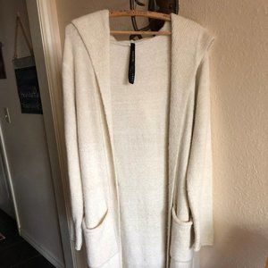 Full length cream colored sweater.